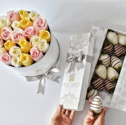 caja de rosas en tonos pasteles con fresas con chocolate